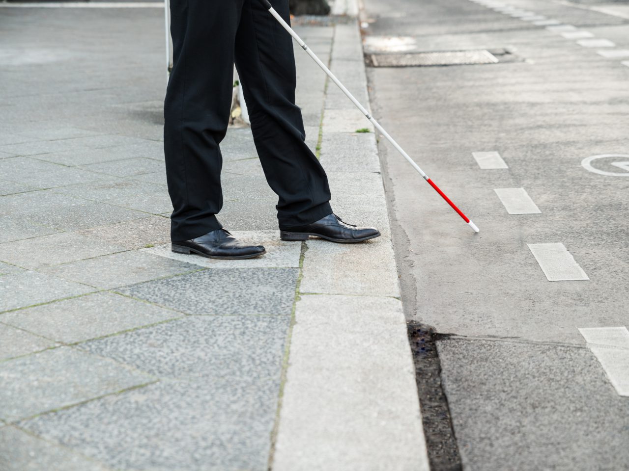 Low Section Of A Blind Person Crossing Street ...