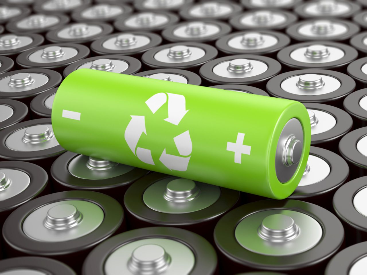 Battery recycling concept. Green battery with recycling symbol, surrounded by ot ...