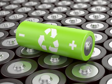 Battery recycling concept. Green battery with recycling symbol, surrounded by ot ...