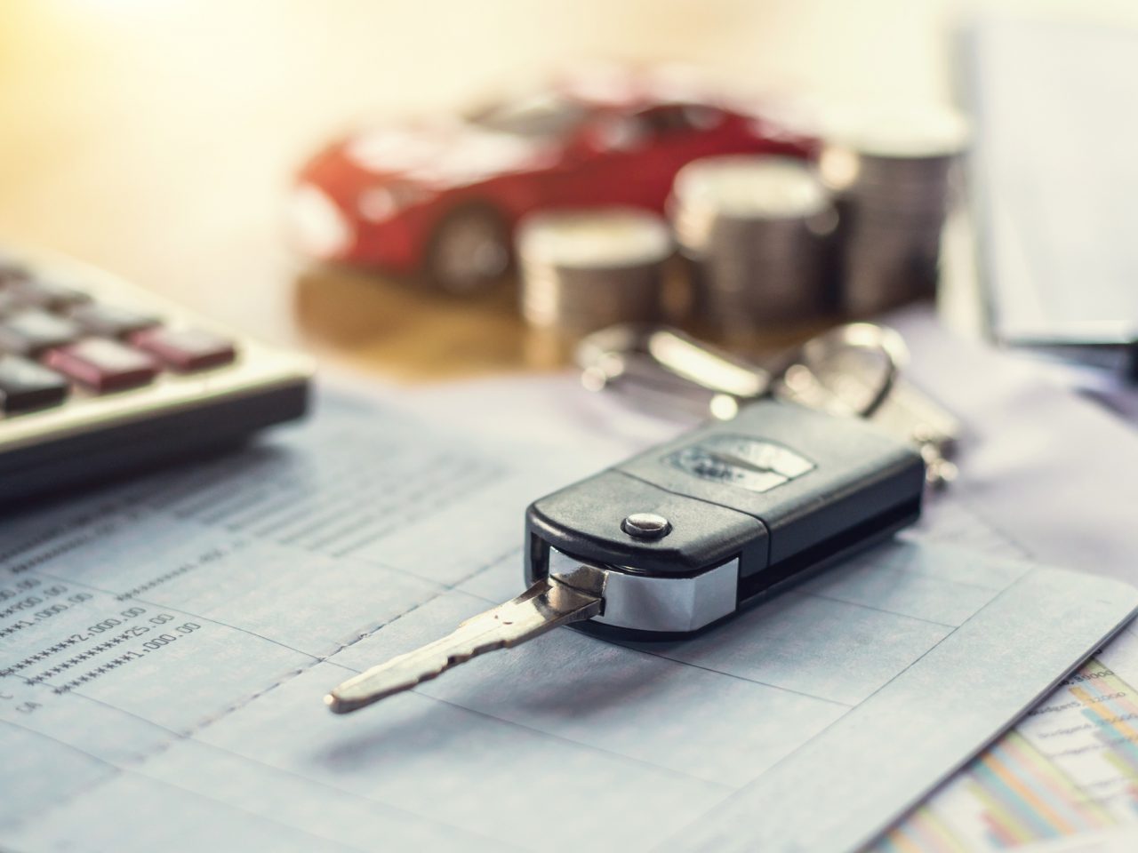 car key with money and calculator on table. concept finance and insurance ...